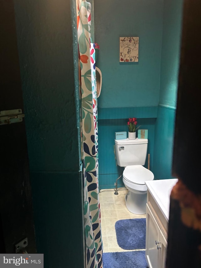 bathroom featuring vanity, toilet, and tile patterned floors