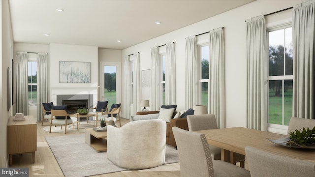 living room featuring a wealth of natural light and light hardwood / wood-style floors