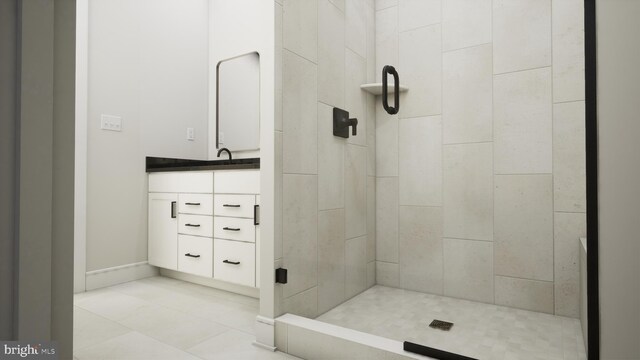 bathroom featuring tiled shower, vanity, and tile patterned flooring