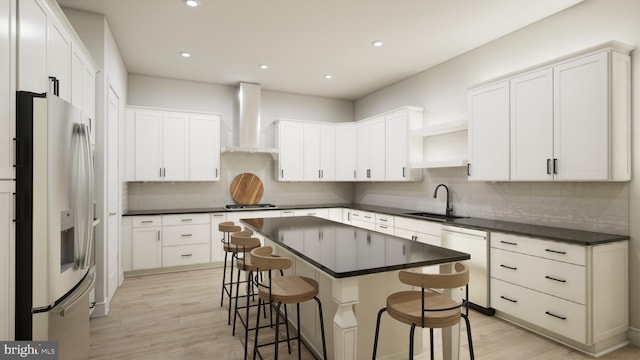 kitchen with white cabinetry, stainless steel appliances, wall chimney range hood, and light wood-type flooring