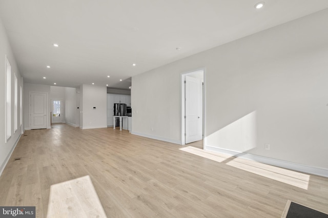 unfurnished living room featuring light hardwood / wood-style floors