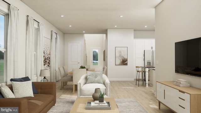 living room featuring a wealth of natural light and light hardwood / wood-style flooring