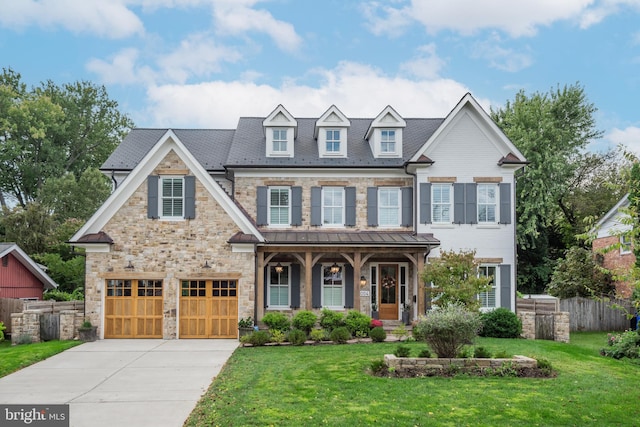 view of front of property featuring a front yard, a garage, and a porch