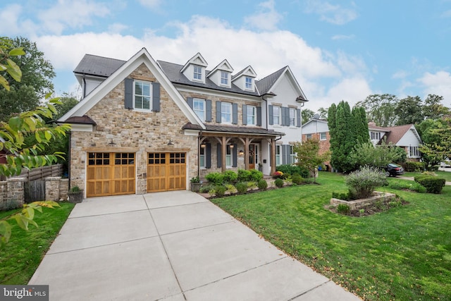 craftsman inspired home with a garage and a front yard