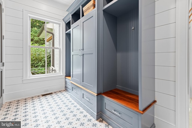 mudroom with wood walls