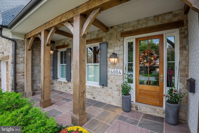 view of exterior entry with a porch