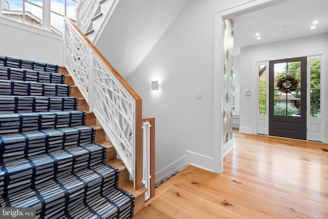 entrance foyer featuring light wood-type flooring and a high ceiling