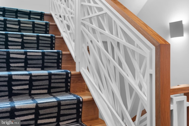 stairs featuring wood-type flooring