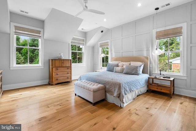 bedroom featuring multiple windows, ceiling fan, and light hardwood / wood-style flooring