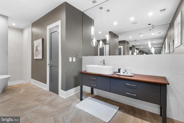 bathroom with vanity and tasteful backsplash