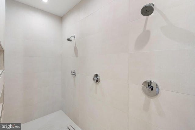 bathroom with tiled shower