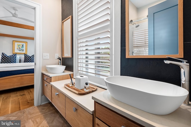 bathroom featuring vanity, a shower, and parquet flooring