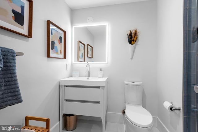 bathroom with tile patterned floors, walk in shower, vanity, and toilet