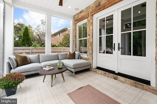 sunroom / solarium featuring ceiling fan