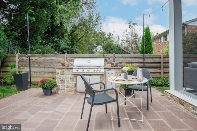 view of patio / terrace featuring exterior kitchen and area for grilling