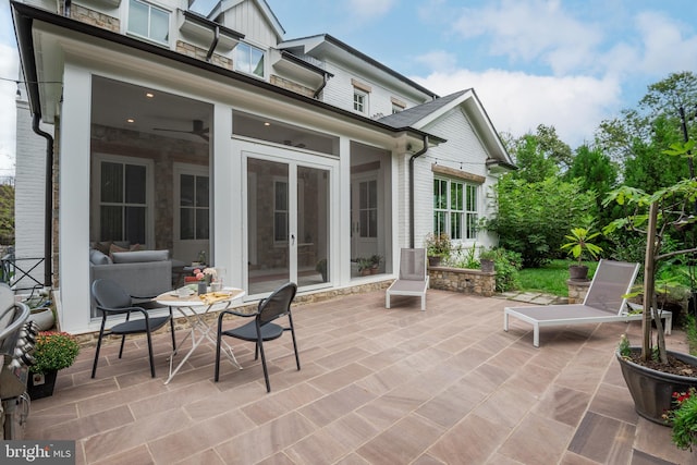 view of patio featuring a sunroom