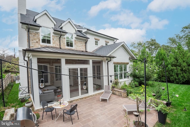 back of house with a patio and a sunroom