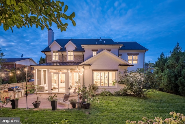 back of property featuring a yard and a patio area