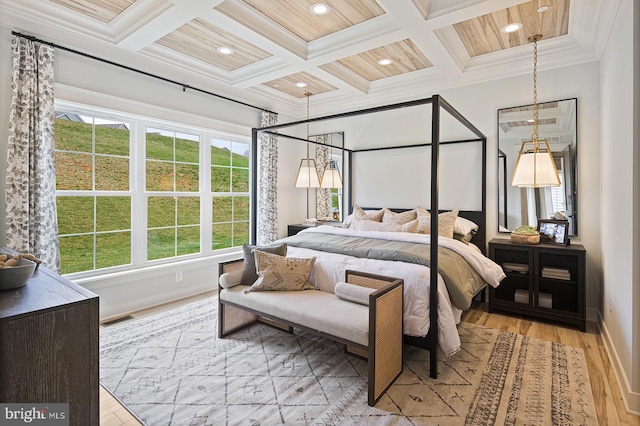 bedroom with baseboards, ornamental molding, coffered ceiling, and light wood-style flooring
