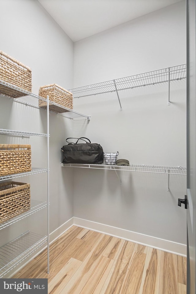 spacious closet with wood finished floors