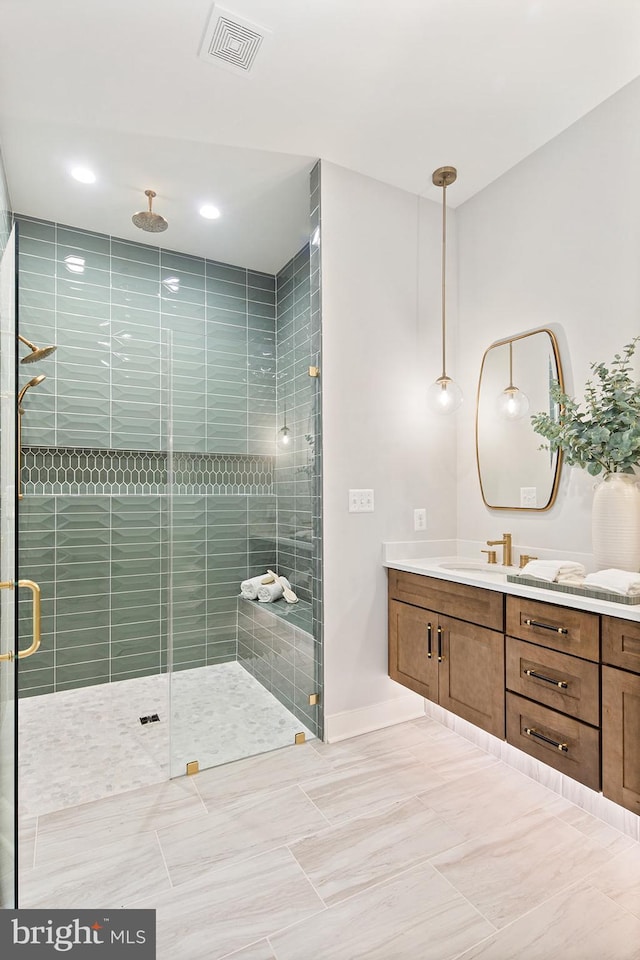 bathroom with vanity, recessed lighting, baseboards, visible vents, and a stall shower