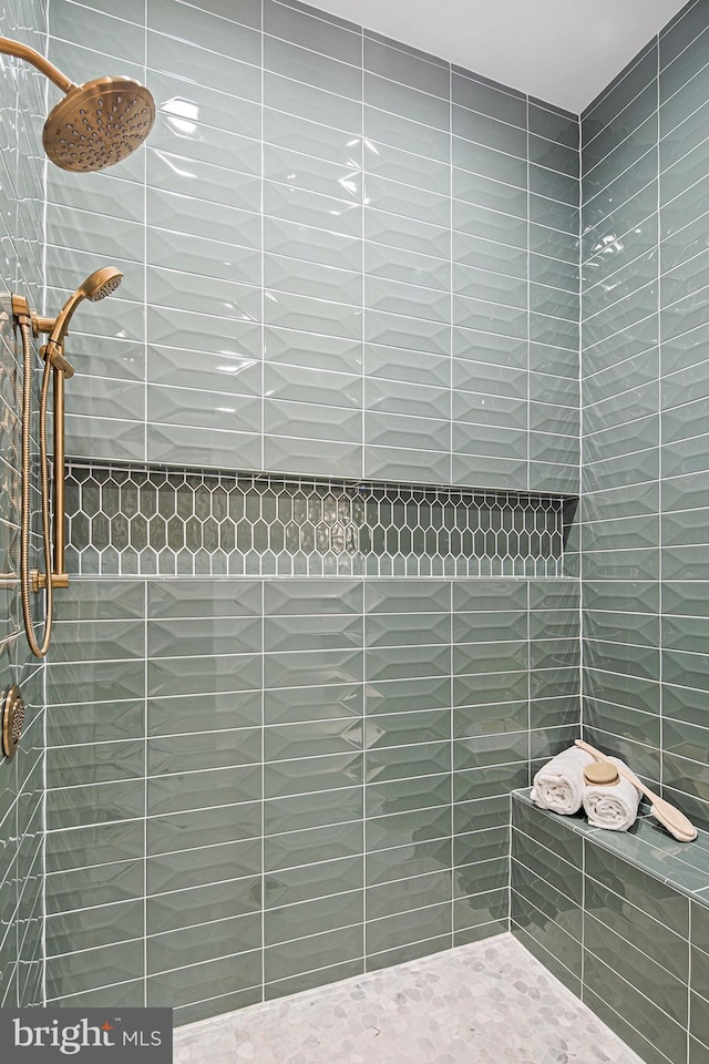 full bathroom with tiled shower