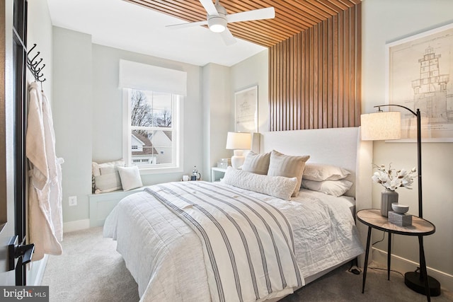 bedroom with carpet floors, a ceiling fan, and baseboards