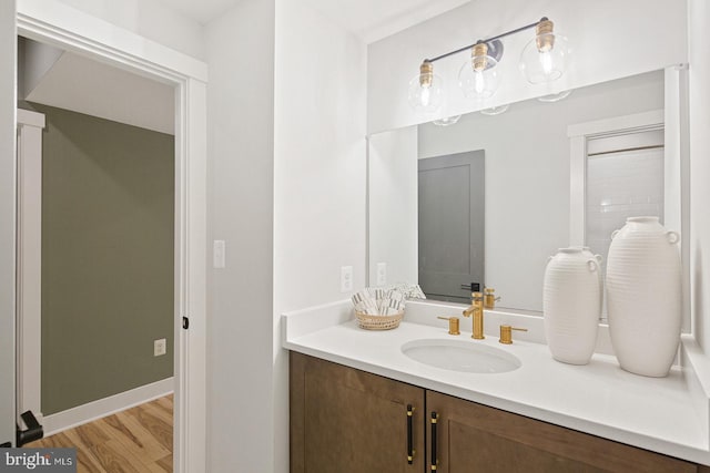 bathroom featuring wood finished floors and vanity