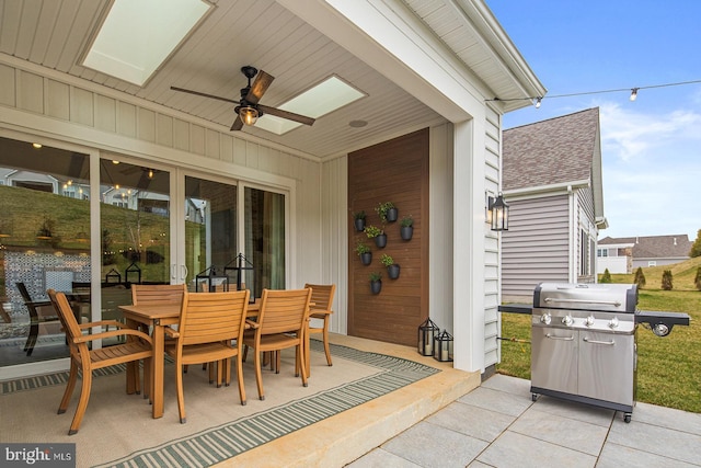 view of patio featuring ceiling fan, outdoor dining area, and a grill
