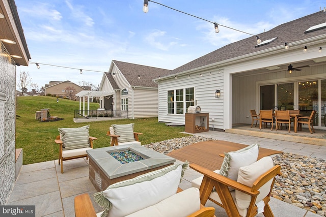view of patio / terrace with ceiling fan, a fire pit, a pergola, and outdoor dining space