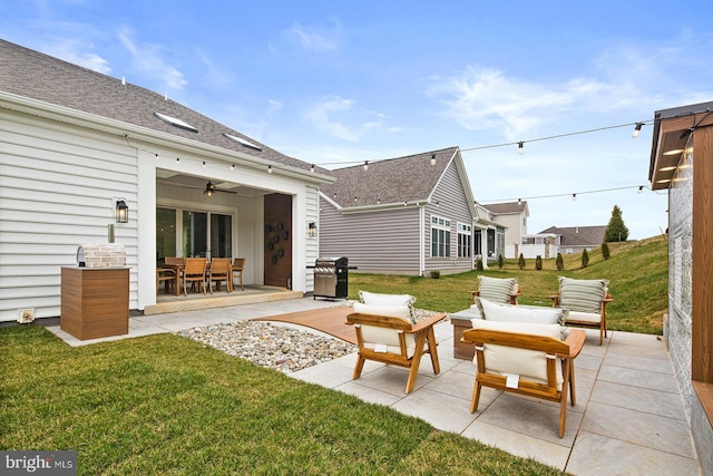 back of property with roof with shingles, outdoor dining space, an outdoor living space, a patio area, and a yard