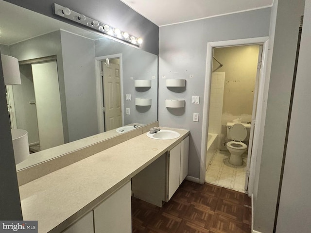 bathroom featuring vanity, toilet, and parquet floors