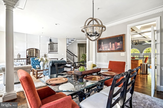 dining area with ceiling fan with notable chandelier, ornamental molding, and dark hardwood / wood-style flooring