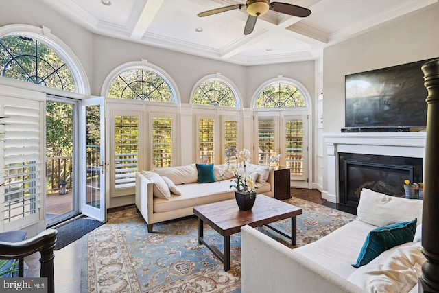 sunroom with beam ceiling, ceiling fan, and coffered ceiling