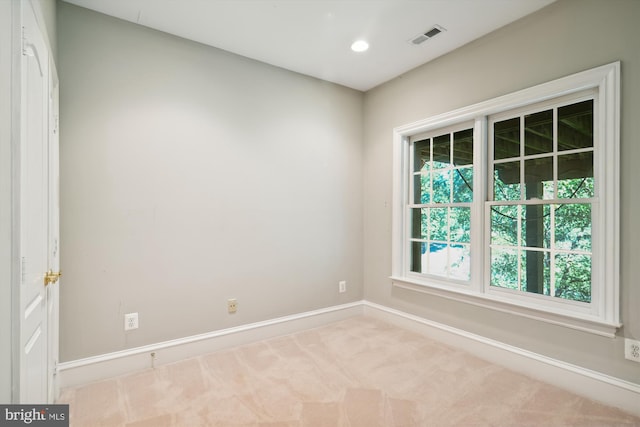 empty room featuring light colored carpet