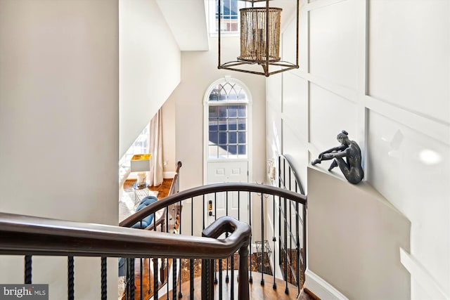 staircase featuring a towering ceiling and a healthy amount of sunlight