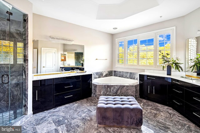 bathroom with shower with separate bathtub and vanity