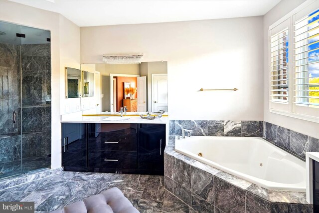 bathroom with vanity and separate shower and tub