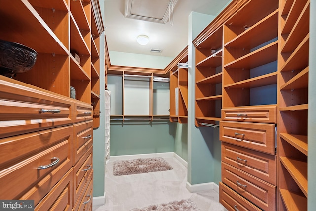 walk in closet featuring light colored carpet