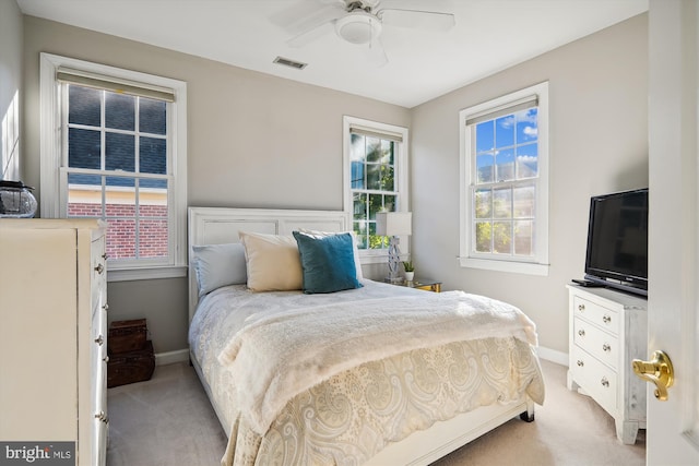 bedroom featuring light carpet and ceiling fan