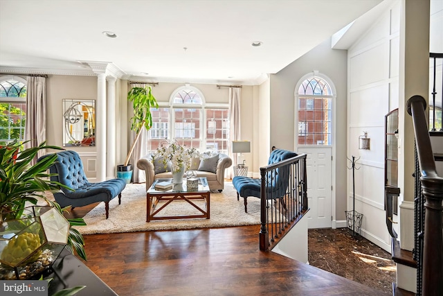 sitting room with plenty of natural light, dark hardwood / wood-style floors, and crown molding