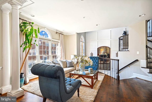 living room with ornamental molding, hardwood / wood-style flooring, and decorative columns