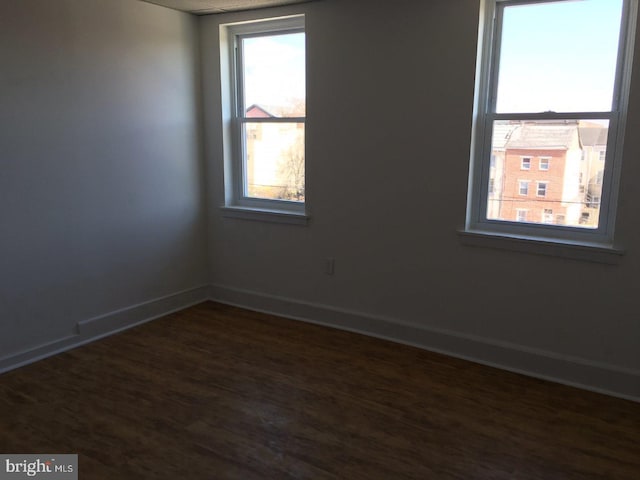 spare room featuring dark hardwood / wood-style flooring