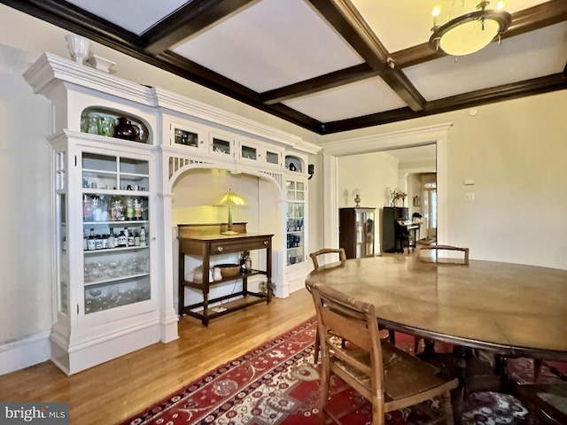 dining room with coffered ceiling, hardwood / wood-style floors, and beamed ceiling