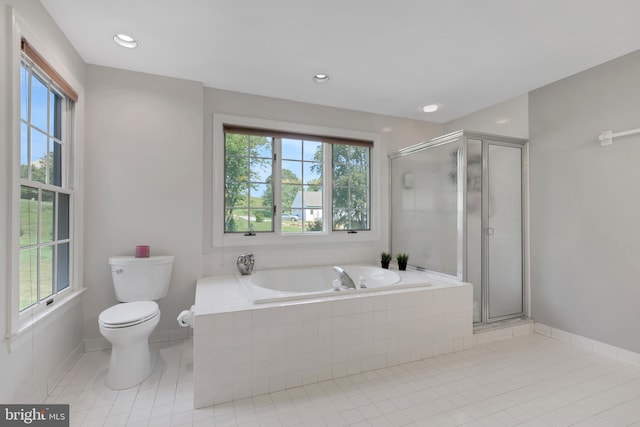 bathroom featuring separate shower and tub, tile patterned flooring, and toilet