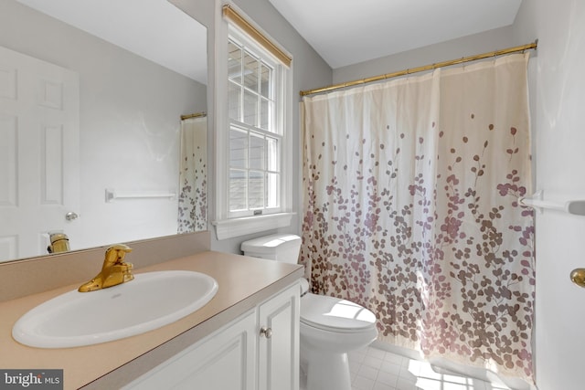 bathroom featuring tile patterned floors, walk in shower, vanity, and toilet