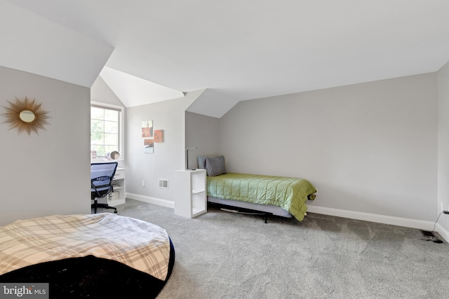 carpeted bedroom featuring vaulted ceiling