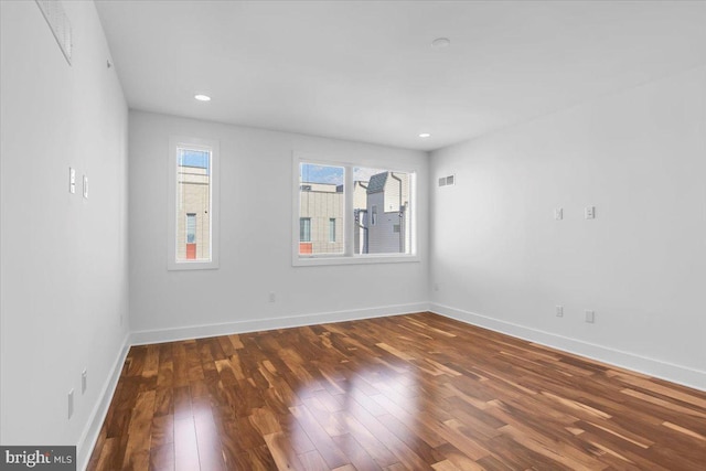 unfurnished room with dark wood-type flooring