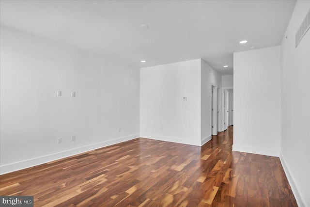 spare room featuring dark hardwood / wood-style flooring