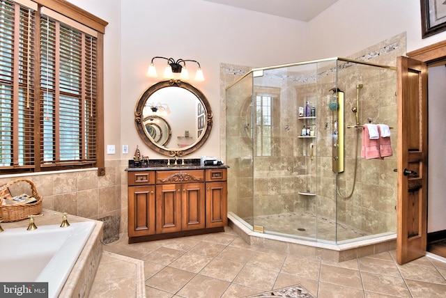 bathroom with vanity, plus walk in shower, and tile patterned floors